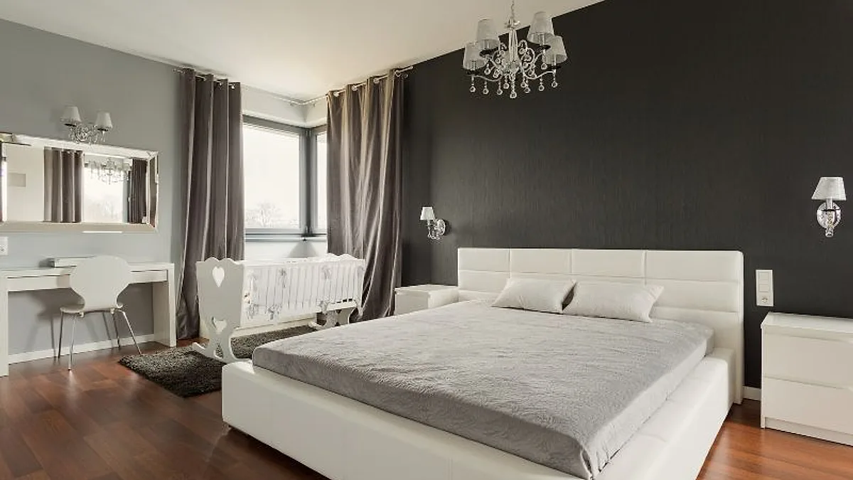 Cama king size em quarto amplo com parede escura